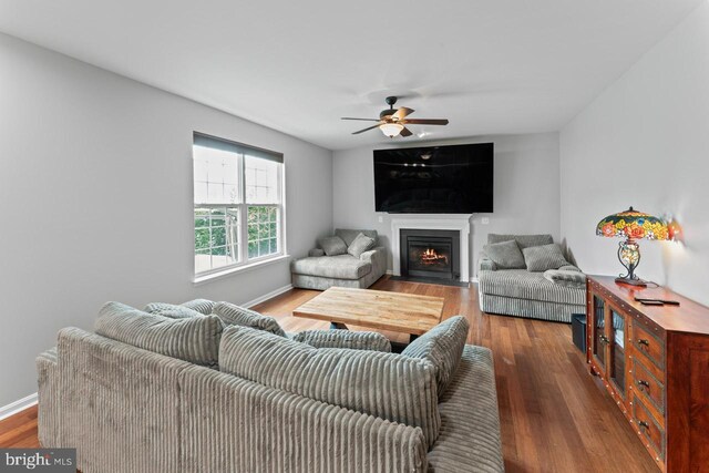 5971 Schooner Cir, King George, VA 22485 - living room featuring a fireplace with flush hearth, wood finished floors, a ceiling fan, and baseboards