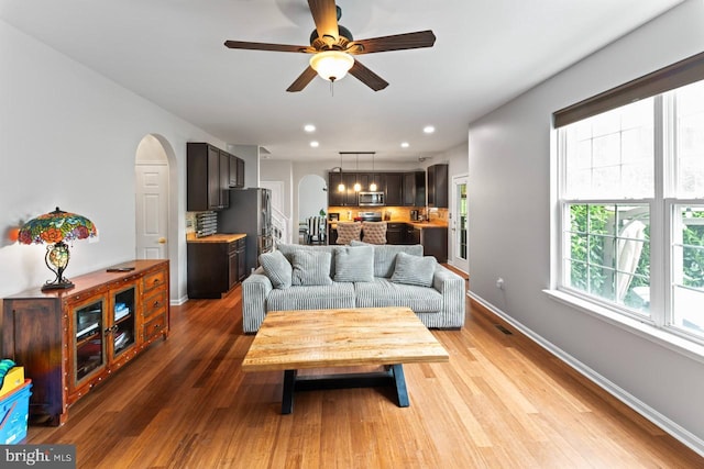 5971 Schooner Cir, King George, VA 22485 - living room featuring arched walkways, ceiling fan, light wood finished floors, baseboards, and recessed lighting
