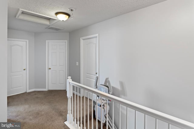 5971 Schooner Cir, King George, VA 22485 - hall with an upstairs landing, carpet floors, attic access, a textured ceiling, and baseboards