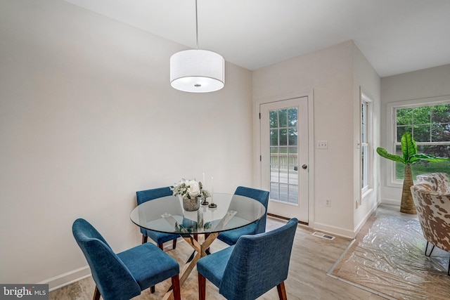dining room with light wood-style flooring and baseboards