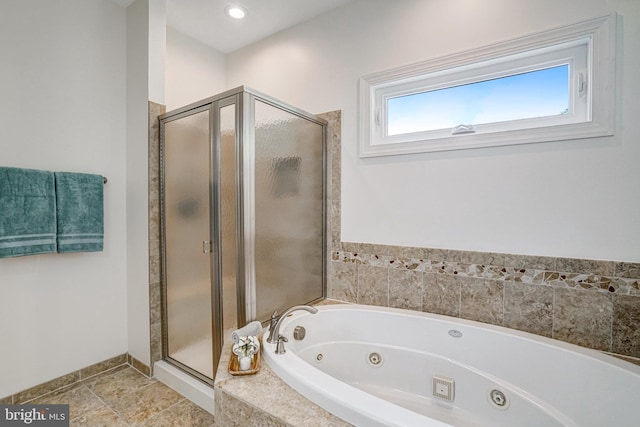 bathroom with a shower stall, a whirlpool tub, and baseboards