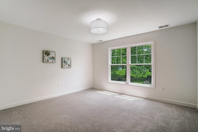 carpeted empty room with baseboards