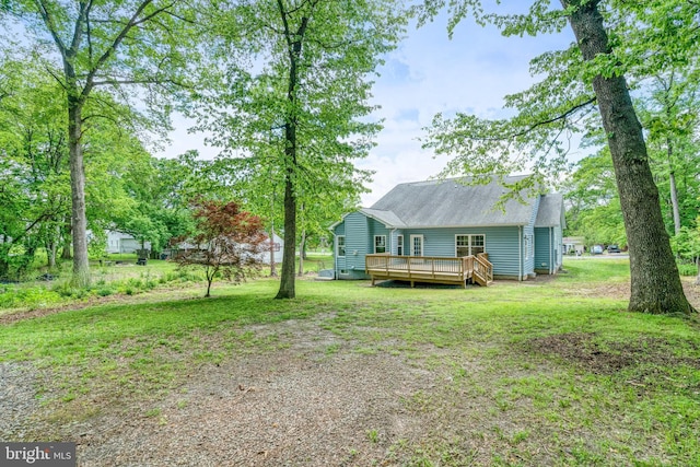 view of green lawn featuring a deck
