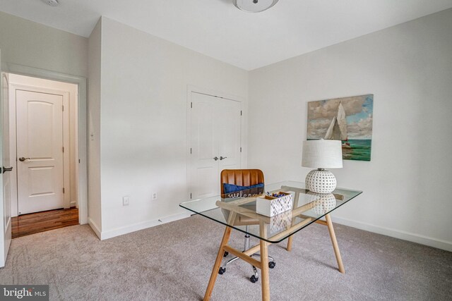 carpeted home office with baseboards