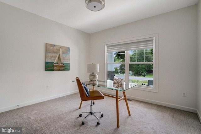 home office featuring carpet and baseboards