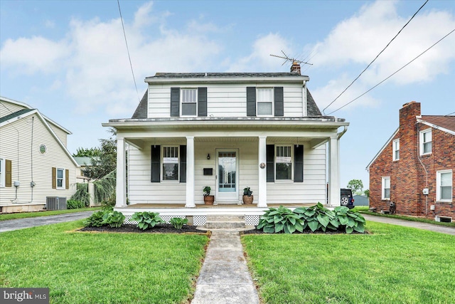bungalow-style home with a front lawn, central air condition unit, and covered porch