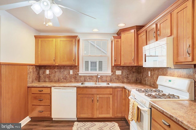 kitchen featuring a ceiling fan, white appliances, a sink, dark wood-type flooring, and light countertops
