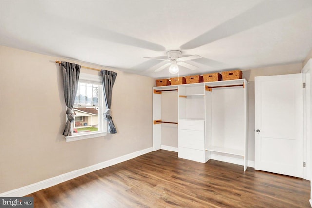 unfurnished bedroom featuring baseboards, a closet, a ceiling fan, and dark wood-type flooring