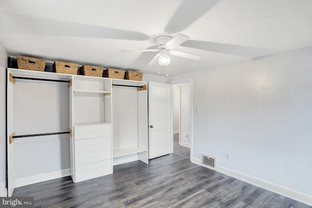 unfurnished bedroom featuring a ceiling fan, baseboards, dark wood-type flooring, and visible vents