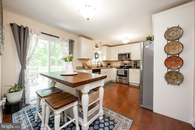926 Pierce Rd, Norristown, PA 19403 - kitchen featuring appliances with stainless steel finishes, a sink, dark wood finished floors, white cabinets, and butcher block countertops