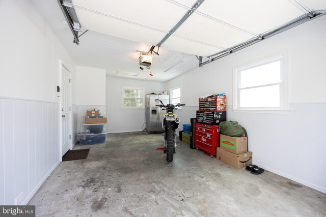 926 Pierce Rd, Norristown, PA 19403 - garage with stainless steel refrigerator with ice dispenser and a garage door opener