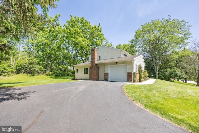 926 Pierce Rd, Norristown, PA 19403 - view of front of property featuring brick siding, a garage, driveway, a chimney, and a front yard