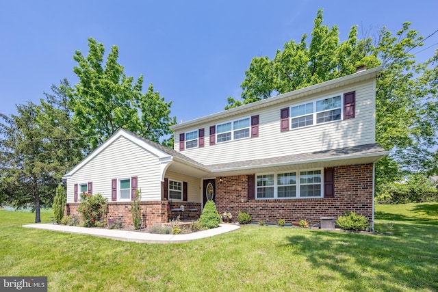 926 Pierce Rd, Norristown, PA 19403 - view of front of property featuring brick siding, a front lawn, and a chimney