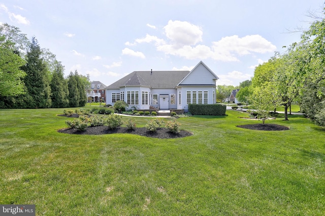 back of property with a yard