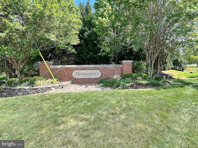 community sign featuring a lawn