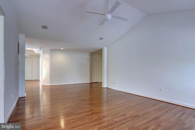 unfurnished living room with a ceiling fan, wood finished floors, vaulted ceiling, and baseboards
