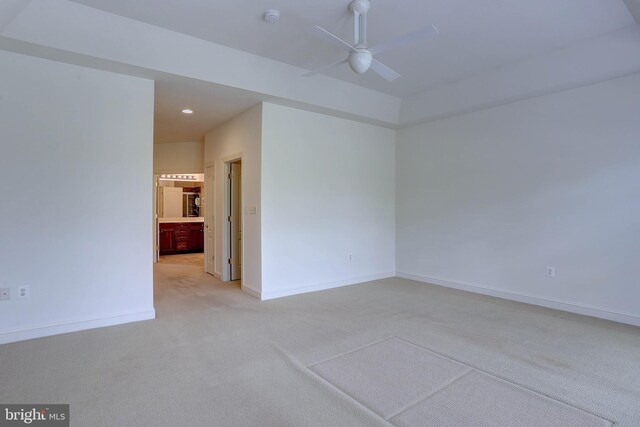 spare room featuring light carpet, a ceiling fan, baseboards, a smoke detector, and recessed lighting