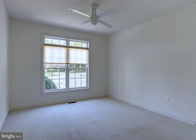 empty room featuring carpet and baseboards