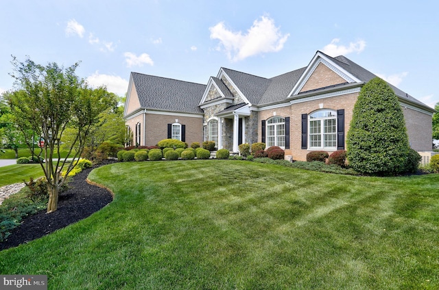 view of front of house featuring a front lawn and brick siding