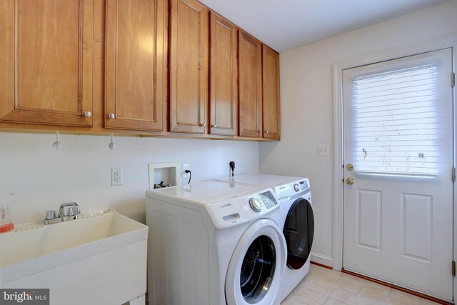 laundry room featuring cabinet space, separate washer and dryer, and light tile patterned flooring