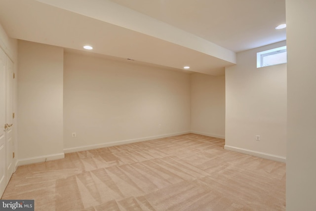basement with light colored carpet, recessed lighting, and baseboards