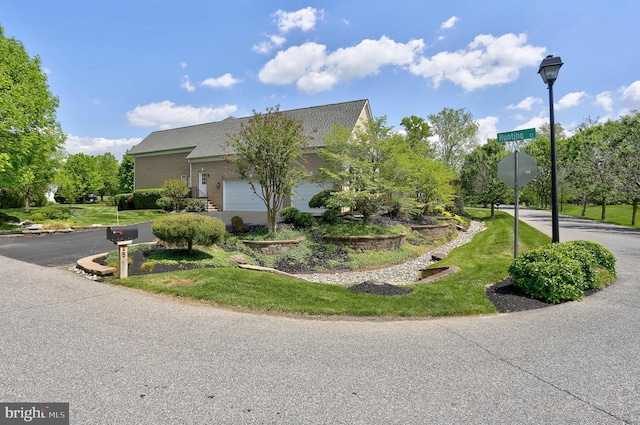 view of home's exterior with a yard and an attached garage