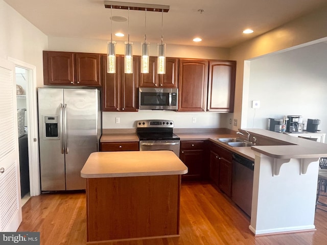 1716 Sunningdale Ln, Hanover, MD 21076 - kitchen featuring appliances with stainless steel finishes, a sink, a peninsula, light wood finished floors, and recessed lighting