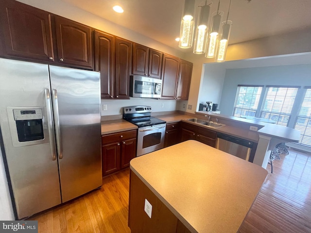 1716 Sunningdale Ln, Hanover, MD 21076 - kitchen with stainless steel appliances, a sink, light wood-type flooring, recessed lighting, and pendant lighting