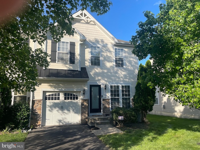 1716 Sunningdale Ln, Hanover, MD 21076 - view of front of property with a garage, stone siding, a front yard, and asphalt driveway