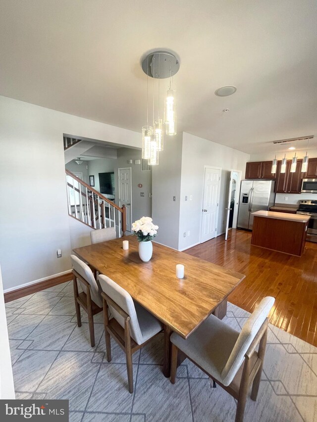1716 Sunningdale Ln, Hanover, MD 21076 - dining space featuring stairs, dark wood-style flooring, and baseboards
