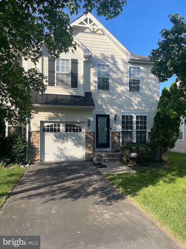 1716 Sunningdale Ln, Hanover, MD 21076 - view of front of home featuring an attached garage, asphalt driveway, stone siding, and a front lawn