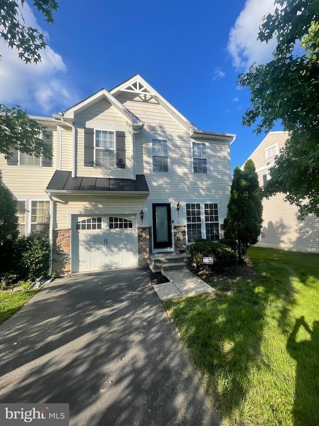 1716 Sunningdale Ln, Hanover, MD 21076 - view of front facade featuring driveway, an attached garage, stone siding, and a front yard