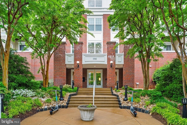 view of property featuring brick siding and french doors