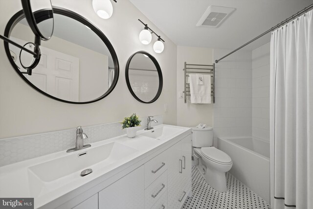 bathroom with toilet, shower / bath combination with curtain, and double vanity