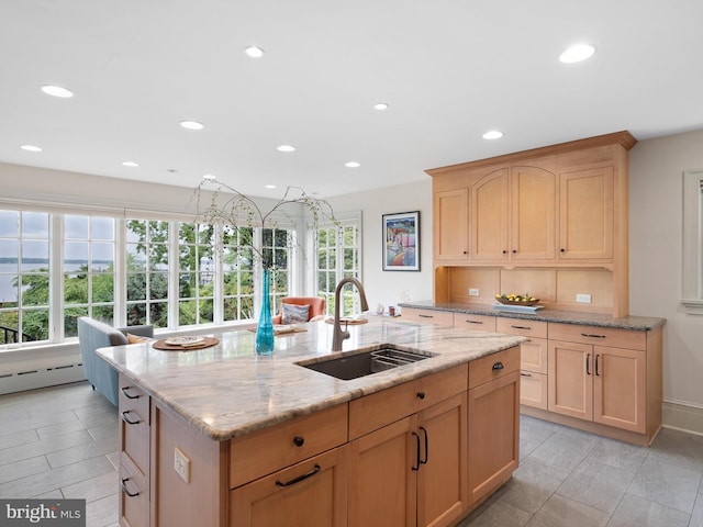 13 The Strand, New Castle, DE 19720 - kitchen with a sink, an island with sink, light brown cabinets, recessed lighting, and light stone countertops