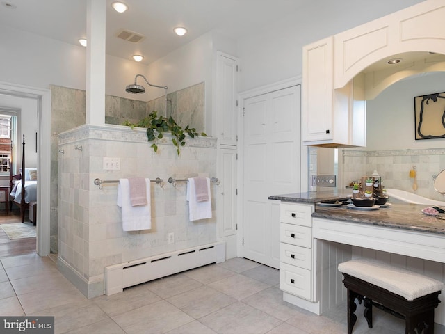 13 The Strand, New Castle, DE 19720 - ensuite bathroom with a baseboard heating unit, tile walls, tile patterned floors, and walk in shower