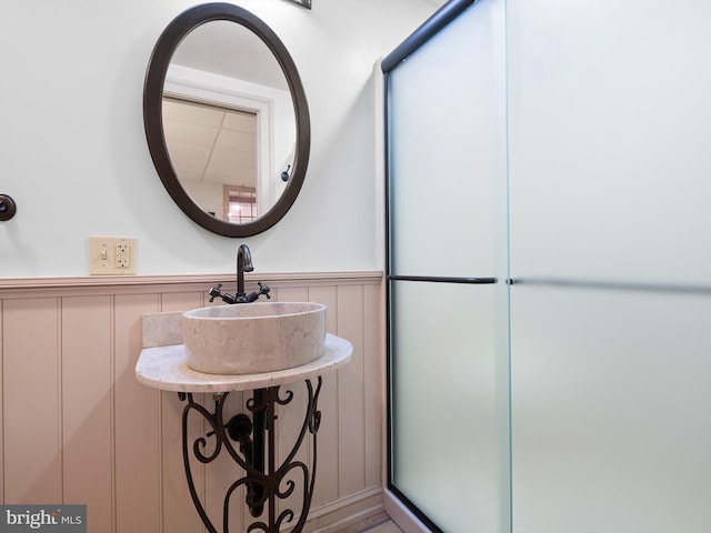 13 The Strand, New Castle, DE 19720 - bathroom featuring wainscoting, a sink, and a decorative wall