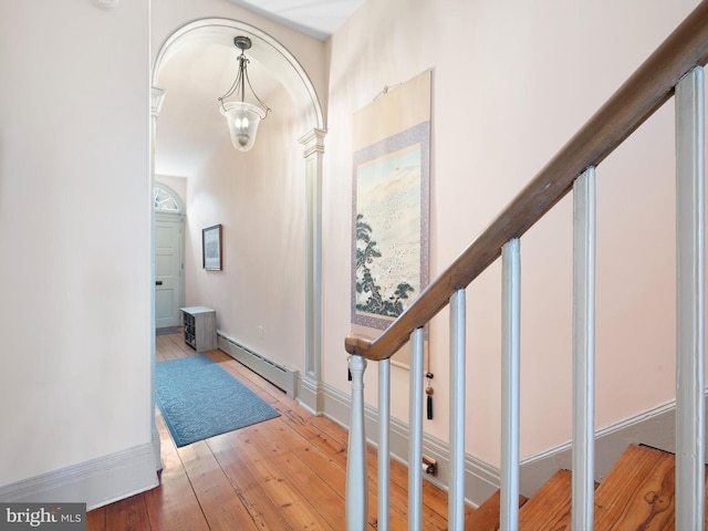 13 The Strand, New Castle, DE 19720 - entryway with light wood-style floors, a baseboard radiator, baseboards, stairway, and a chandelier