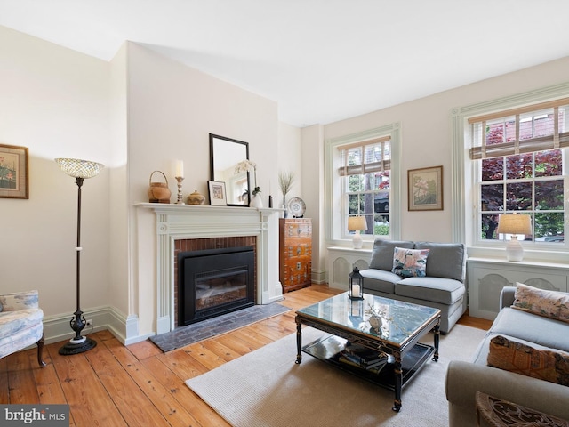 13 The Strand, New Castle, DE 19720 - living area with hardwood / wood-style floors, a brick fireplace, and baseboards