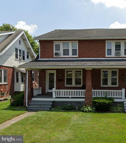 36 W Summit St, Souderton, PA 18964 - view of front of property featuring a porch, brick siding, and a front yard