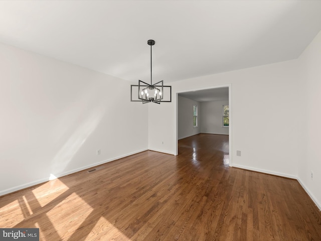 222 Springloch Rd, Silver Spring, MD 20904 - unfurnished dining area featuring a chandelier, wood finished floors, and baseboards