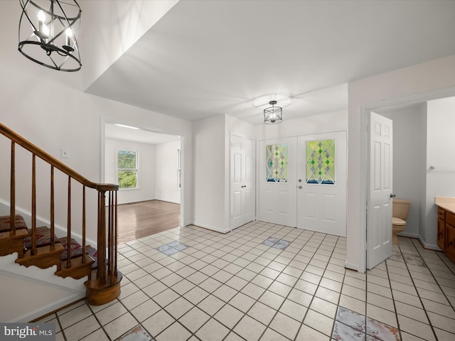 222 Springloch Rd, Silver Spring, MD 20904 - entryway featuring a chandelier, light tile patterned flooring, stairs, and baseboards