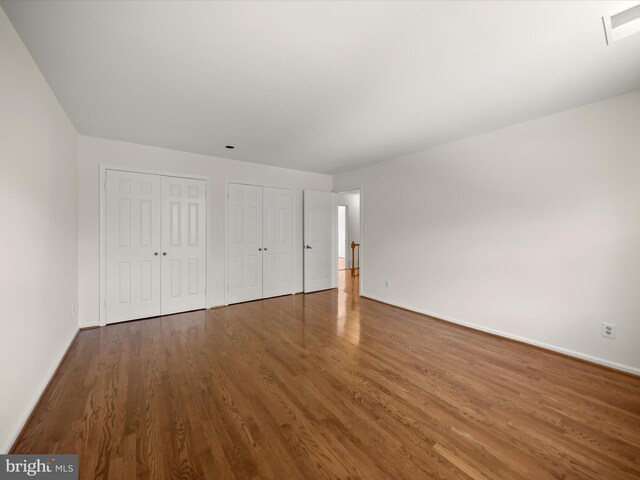 222 Springloch Rd, Silver Spring, MD 20904 - unfurnished bedroom with multiple closets, baseboards, and wood finished floors
