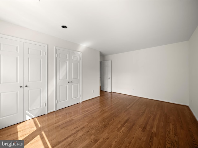 222 Springloch Rd, Silver Spring, MD 20904 - unfurnished bedroom featuring multiple closets, wood finished floors, and baseboards