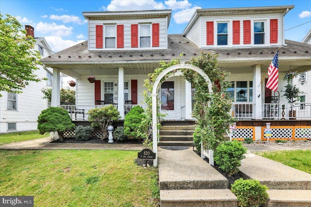 view of front of home with a front yard and covered porch