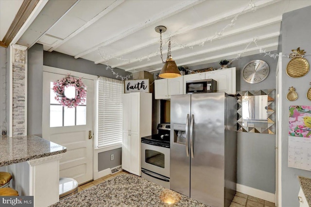 kitchen with appliances with stainless steel finishes, light stone counters, visible vents, white cabinets, and beam ceiling