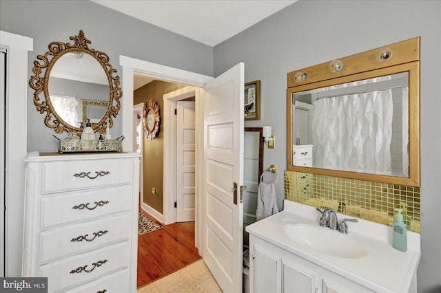 full bathroom featuring backsplash and vanity