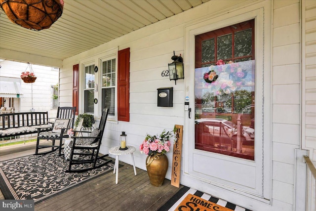 view of exterior entry with covered porch
