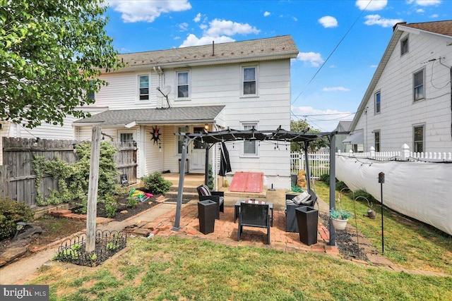 rear view of property with an outdoor hangout area, a patio area, a yard, and a fenced backyard