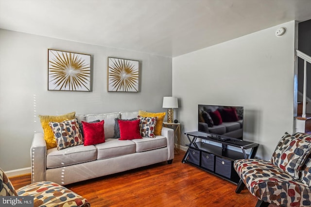 living room with baseboards and wood finished floors
